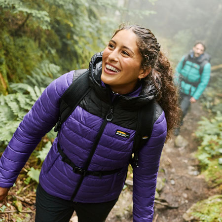Deux randonneurs explorant une forêt, vêtus de vestes isolées Chlorophylle adaptées aux activités de plein air